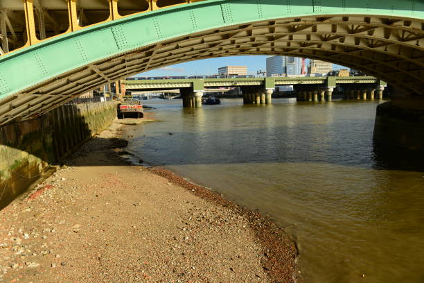 City bridge of the river Thames with beach on a sunny day.