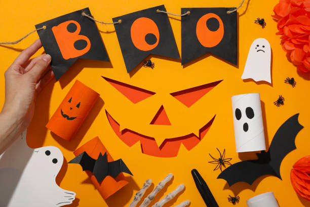 istock Paper decorations for Halloween on orange background, top view 2172576072