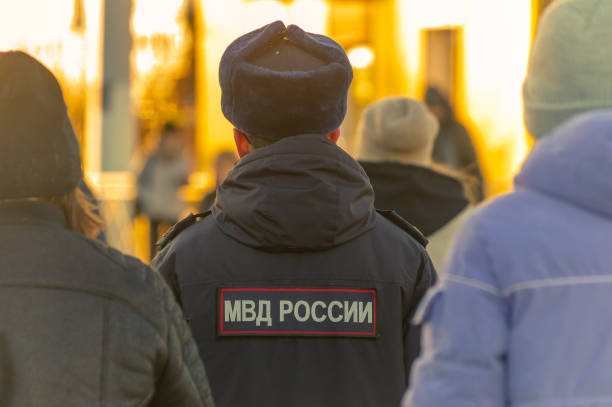 Saint-Petersburg, Russia - 11 March 2024. Russian policeman in crowd of people. view from back