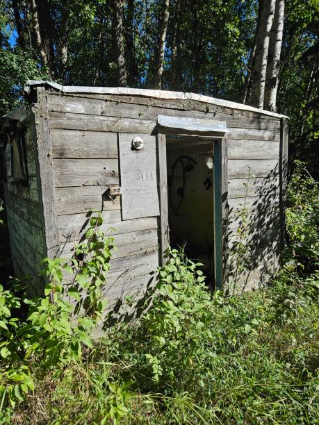 istock Rustic, old and weathered small wooden shed with an open doorway. 2172576711