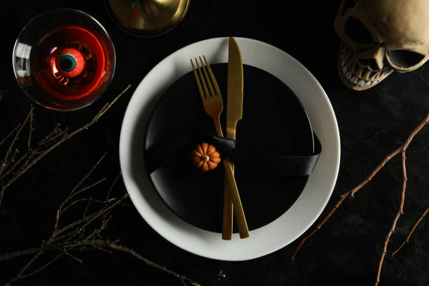 istock Festive table set for Halloween dinner with candles and cutlery 2172577958