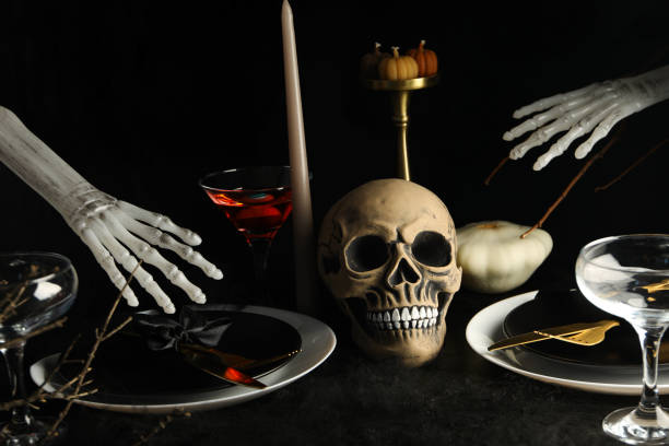 istock Festive table set with candles and a skull 2172578817