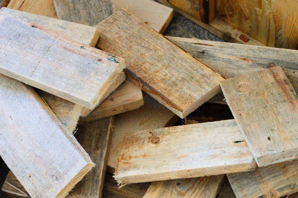 Assorted weathered wooden planks stacked together for construction or carpentry uses