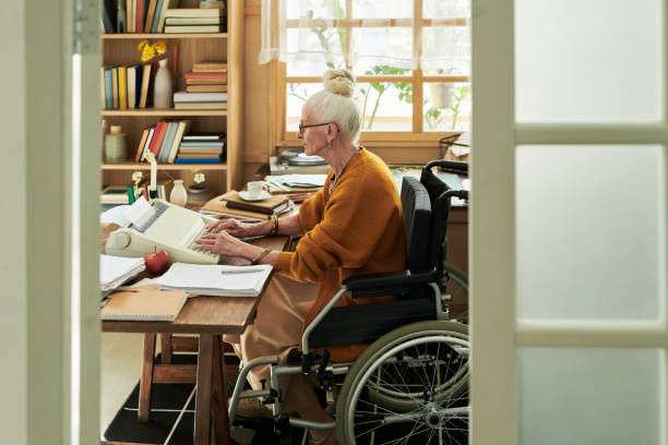 istock Writing a Letter at Home Office Desk While Using Wheelchair 2172580879