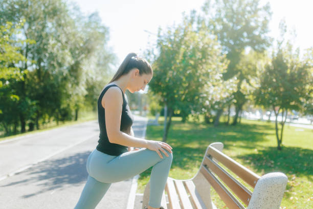 istock Active Brunette Woman Doing Gymnastic Exercises Outside in the Park 2172581574