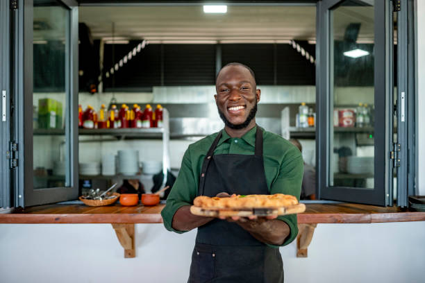 istock Smiling Chef Presenting Freshly Baked Pastries in Kitchen 2172584809