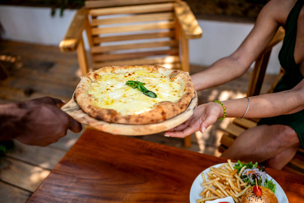 istock Sharing Delicious Pizza at Outdoor Restaurant Table 2172584835