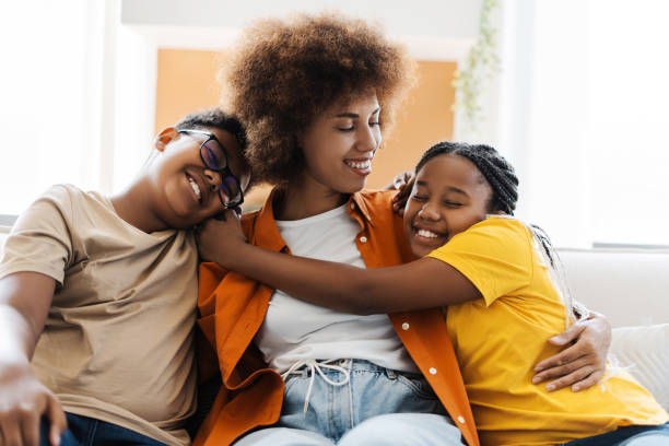 istock Smiling children hugging their attractive mother tenderly 2172585306