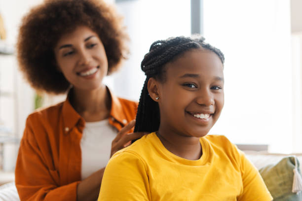 istock Smiling mother making hairstyle for her attractive kid daughter 2172585419