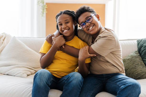 istock Smiling children hugging together tenderly 2172585488