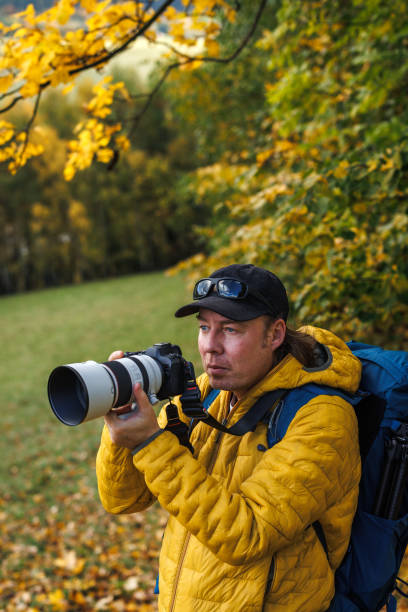 istock Hiker with camera taking picture in wilderness 2172585931