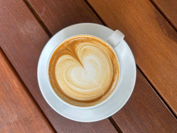 istock a cup of hot Caffe latte on a wooden table. 2172586458