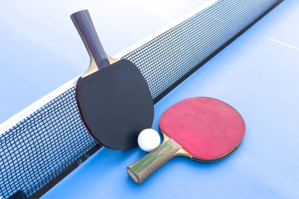 istock tennis rackets for playing ping pong on blue table, ping pong concept 2172587149