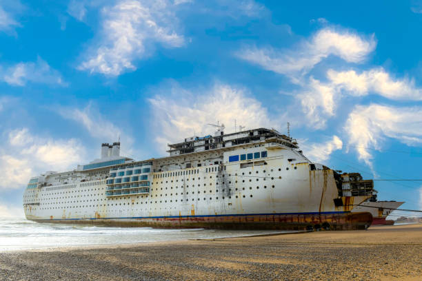 an old ship on the beach on gadani ship breaking yard in Pakistan Gadani Beach is a beach on the Arabian Sea located near the Hub River and Cape Monze in Gadani, Hub District, Balochistan, Pakistan. Gadani Beach is the location of Gadani ship-breaking yard, which is one of the world's largest ship-breaking yards. freight liner stock pictures, royalty-free photos & images