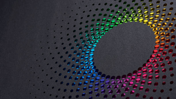 istock Abstract circular paper design with colorful gradient hues emerging through laser-cut holes on black background 2172589689