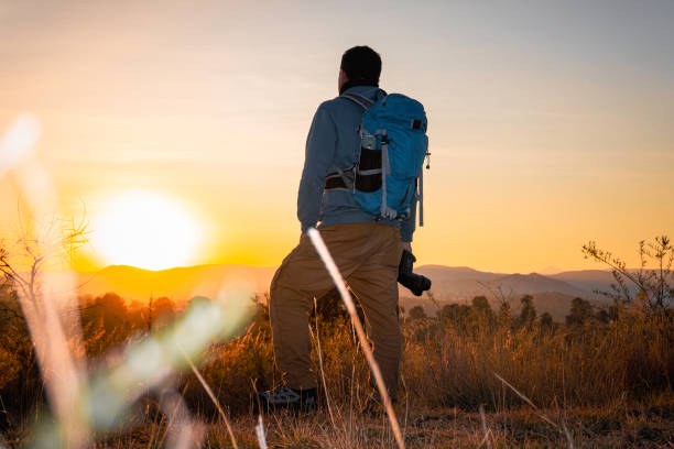 istock photographer, with camera and backpack, immortalizes the spectacular sunrise 2172589915