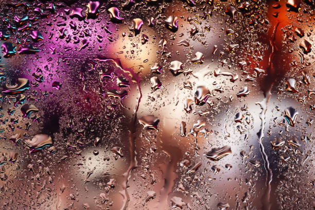 istock Water drops on glass. Raindrops on the window. Abstract background. Multi-colored spots. Texture of drops. 2172590180