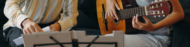 Playing Acoustic Guitar Together with Sheet Music