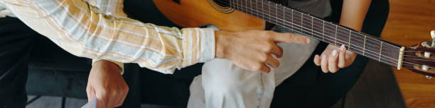 istock Strumming Acoustic Guitar at Cozy Home Setting 2172591219