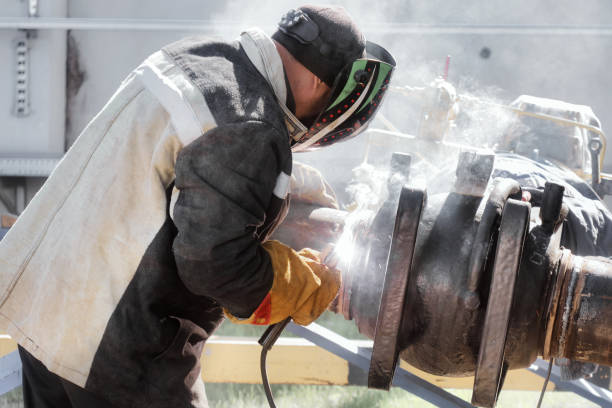 istock Worker welding at a construction site with protective gear in harsh conditions 2172591779