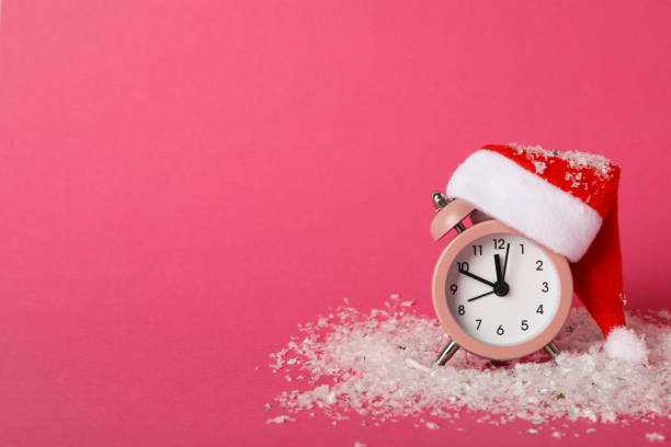 istock A clock with a Santa hat with a New Year's decoration. 2172593746