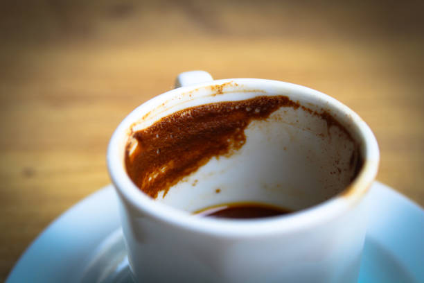 istock Half-Drunk Turkish Coffee in a White Mug with Coffee Grounds Visible, Accompanied by a Glass of Water, and a Traditional Coffee Cup for Reading Coffee Grounds 2172594797