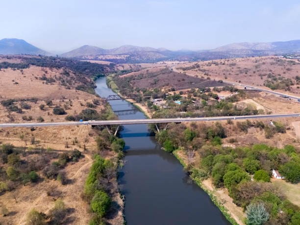 Bridge over the Crocodile River that flows to Hartebeespoort Dam/Lake North West of Johannesburg, surrounded by the Magaliesberg Mountain range.