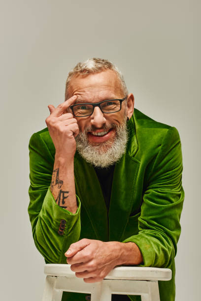 istock A mature man with a beard joyfully expressing excitement against a vibrant backdrop 2172597848