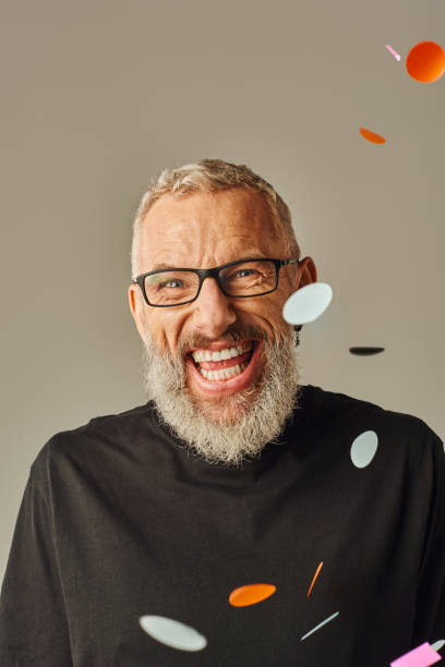 istock Cheerful mature man with glasses joyfully expressing himself against a vibrant background 2172598024