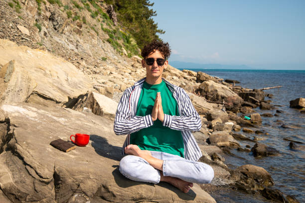 istock A young attractive guy is resting by the sea. 2172599980