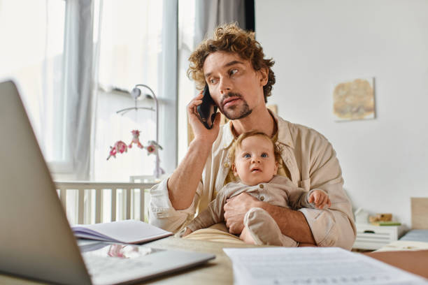 istock A young father balances work and parenting while talking on the phone at home with his son 2172600144