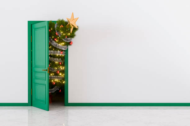 istock Christmas tree entering by the door with white wall background 2172601615