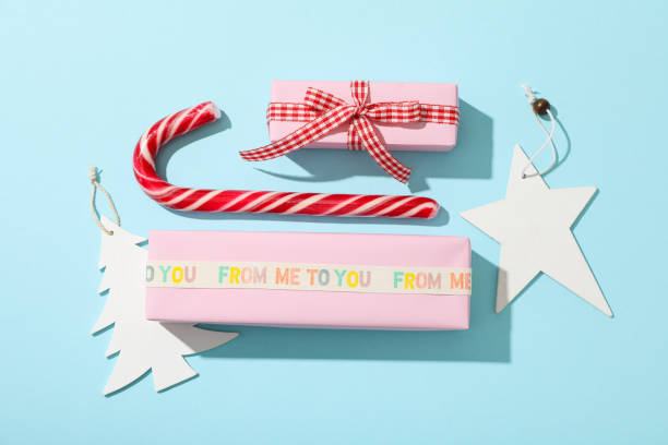 istock Gift boxes, Christmas candy cane and paper decorations on blue background, top view 2172607634