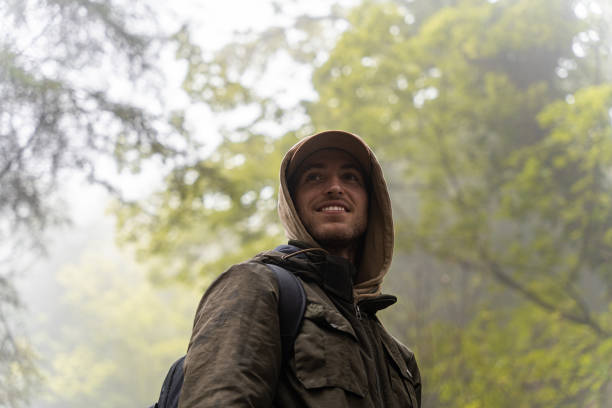 man hiking in the forest on a cool rainy autumn day. Concept of sport in nature