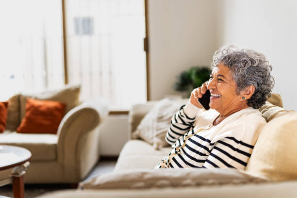 istock Senior woman talking on mobile phone at home 2172609492