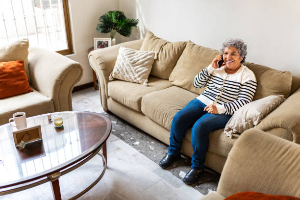 istock Senior woman talking on mobile phone at home 2172609520