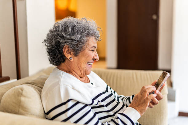 istock Senior woman using mobile phone at home 2172609543
