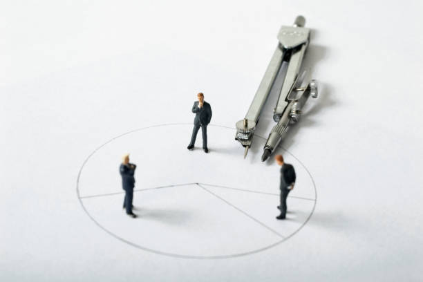 istock Three male businessmen discuss plan on paper - miniature landscape 2172612497