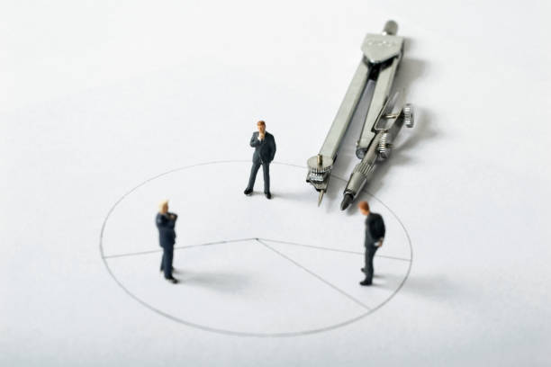 Three male businessmen discuss plan on paper - miniature landscape