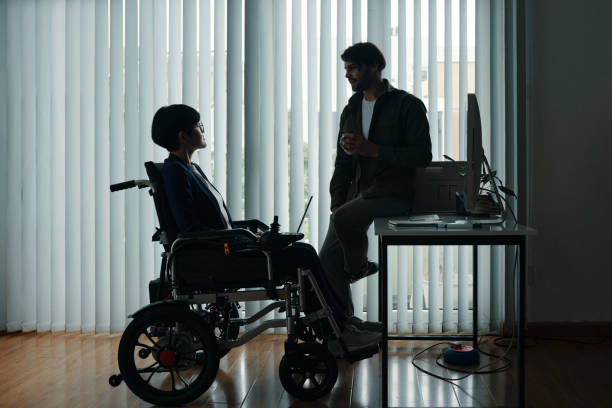 istock Man Talking To His Colleague With Disability 2172612538