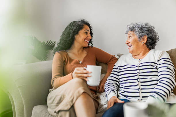 Mother and daughter talking embraced at home