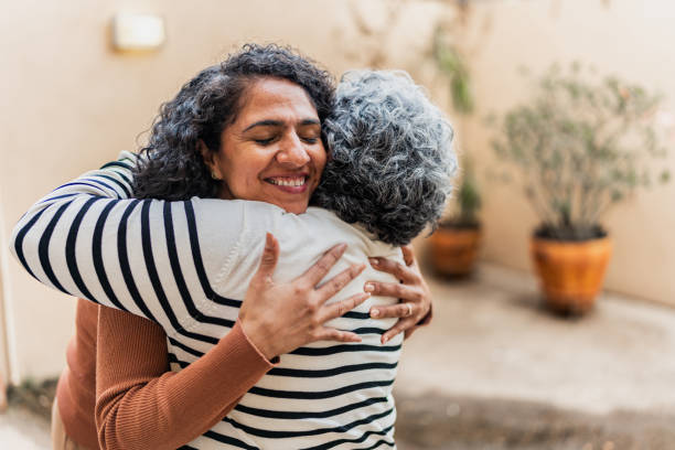 istock Mother and daughter embracing at home 2172615411