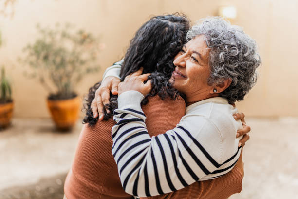 istock Mother and daughter embracing at home 2172615415