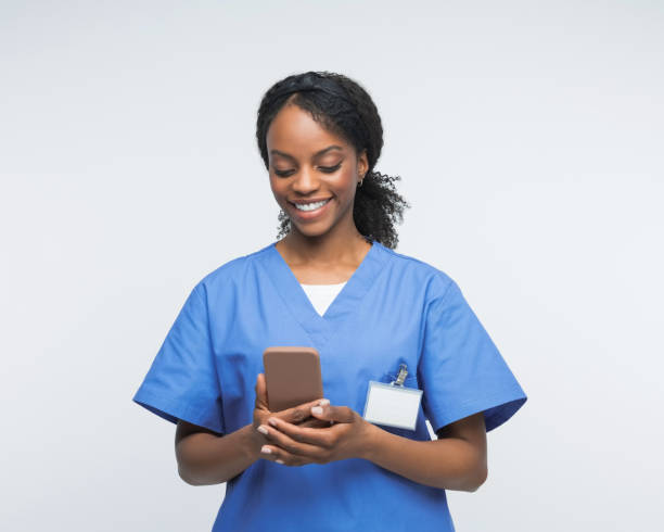 istock Portrait of friendly nurse using smart phone 2172618175