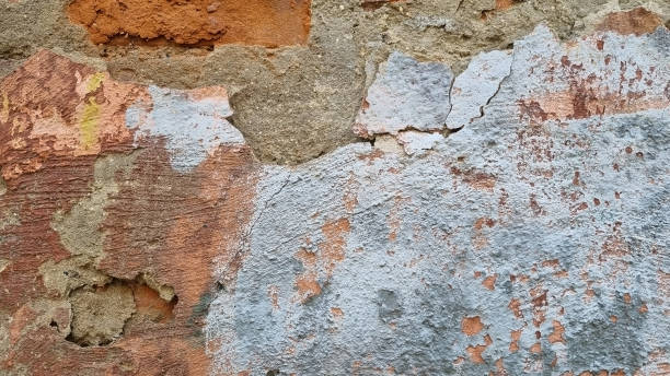 istock Peeling paint on an old wall. Grunge background for design.Selective focus 2172619523