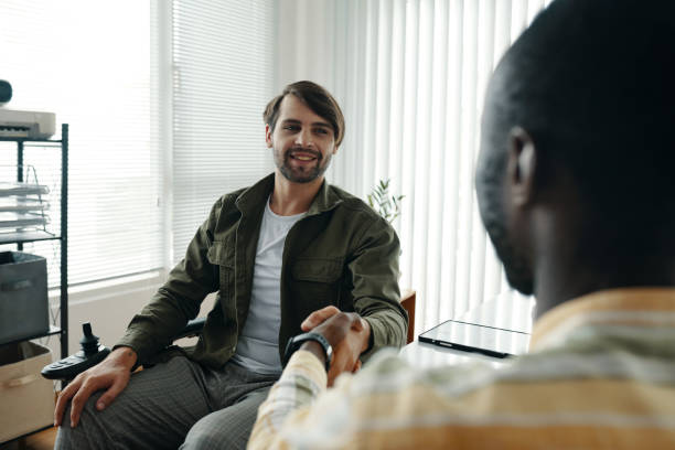 istock Businessman With Disability Greeting His Colleague 2172619526