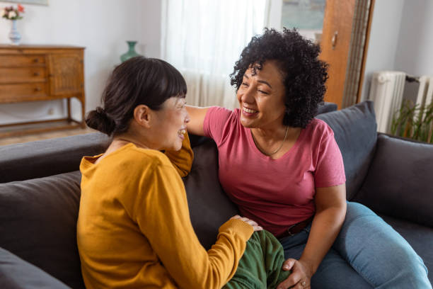 istock Happy lesbian couple enjoying quality time on the sofa 2172620592