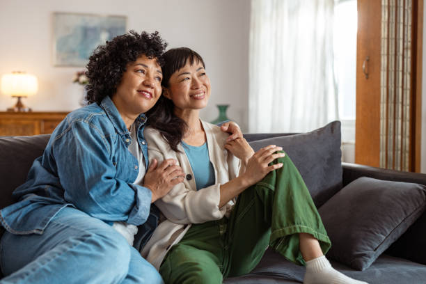 istock Gay couple relaxing on a sofa at home 2172620861