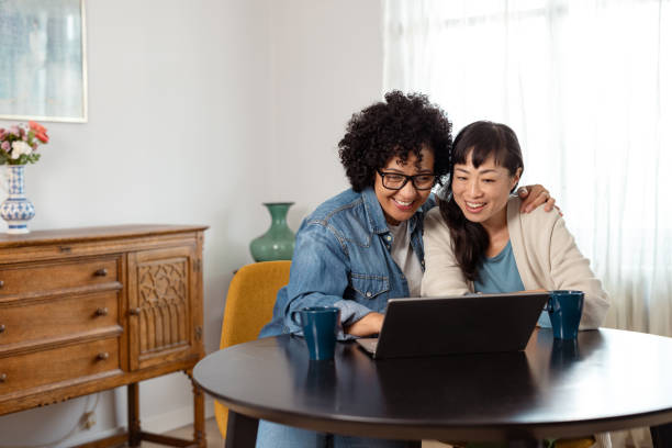 istock A diverse lesbian couple at home using a laptop 2172620888