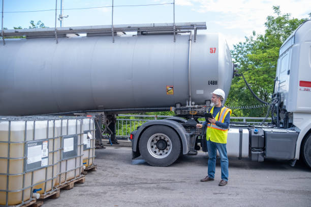 istock A customer accepts a tanker vehicle with lubricants and controls the overflow into a 1000-liter IBC bulk container. 2172624894
